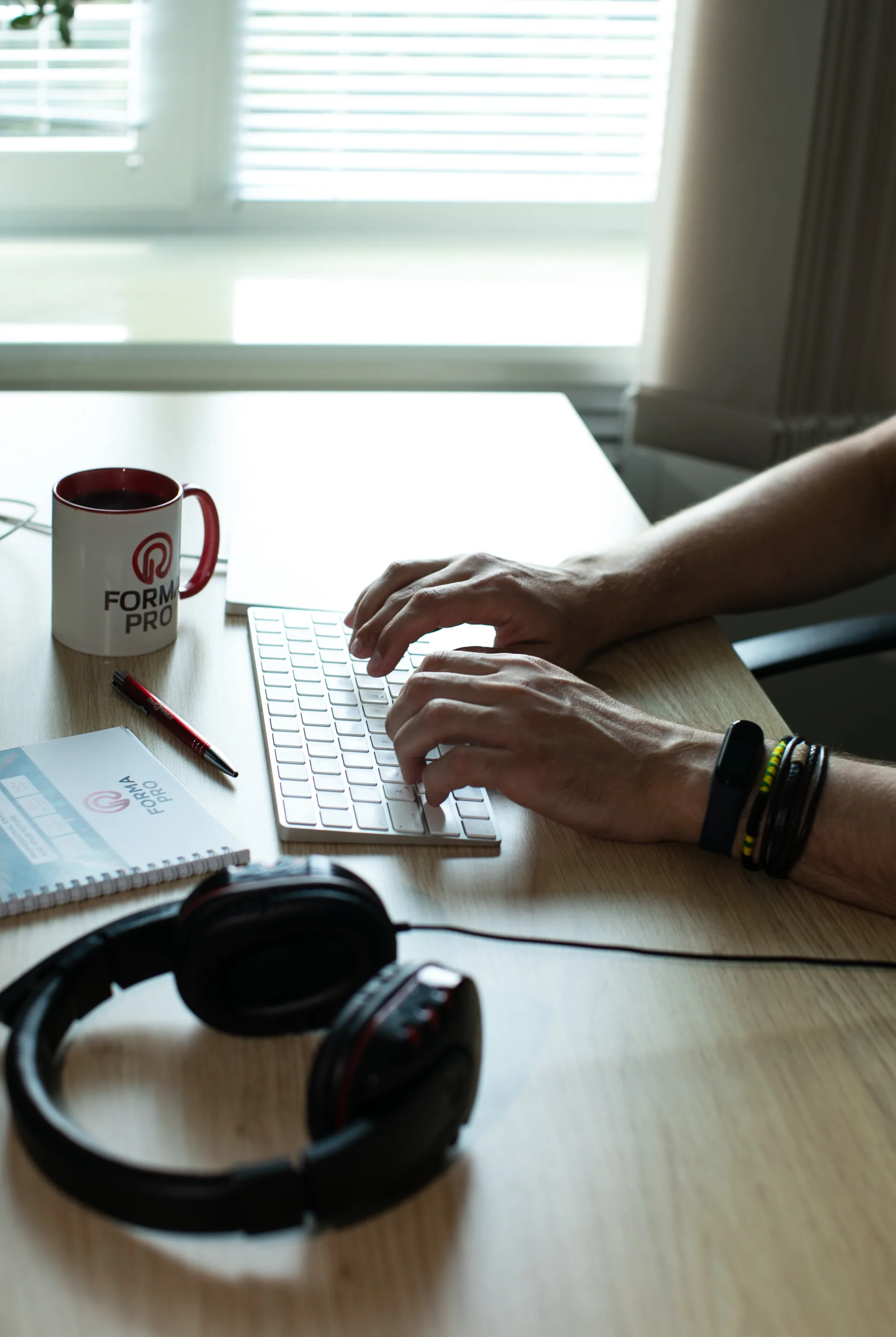Hands working at a keyboard in a Forma Pro workspace.