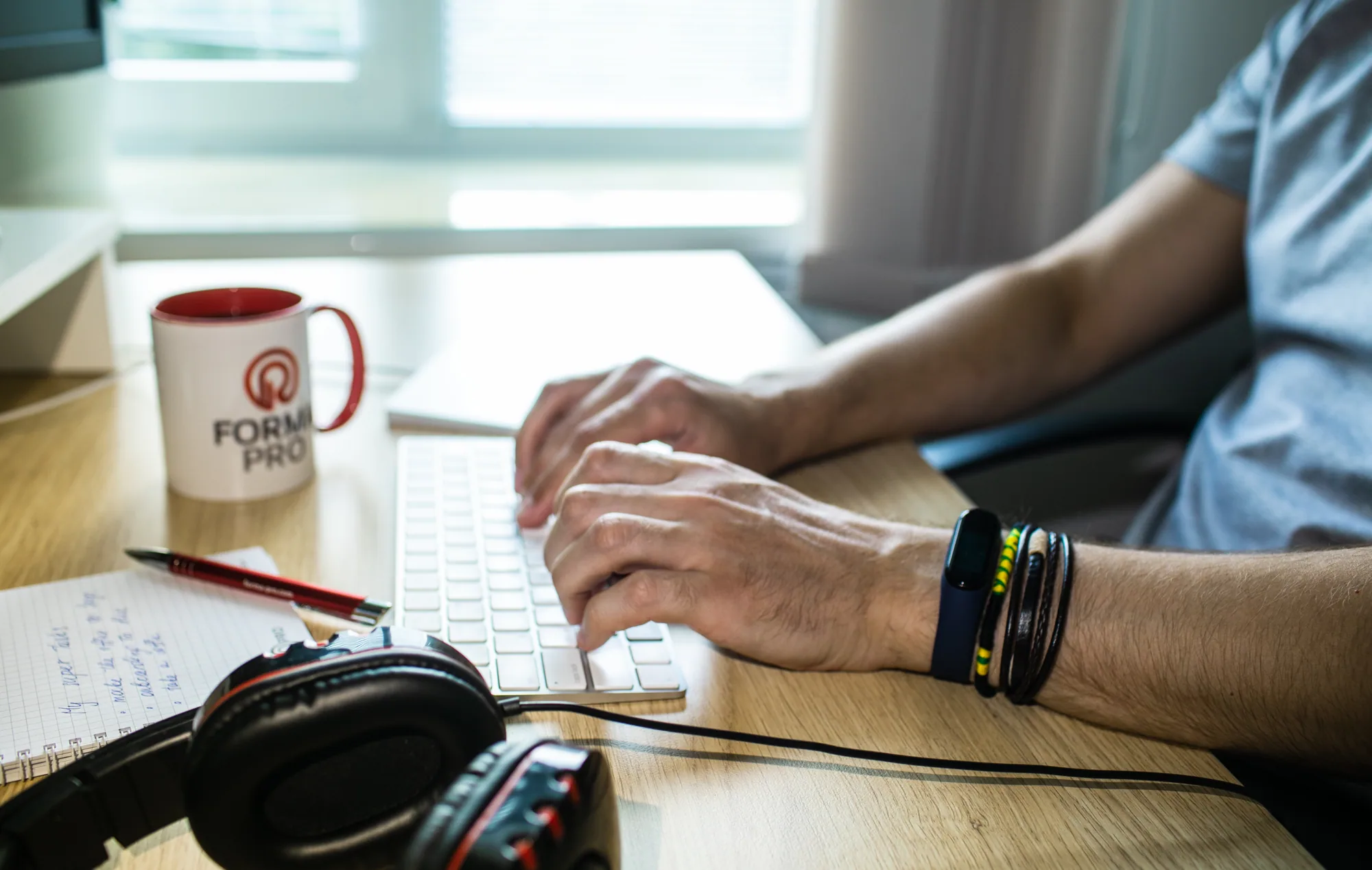 Hands working at a keyboard in a Forma Pro engineering workspace.